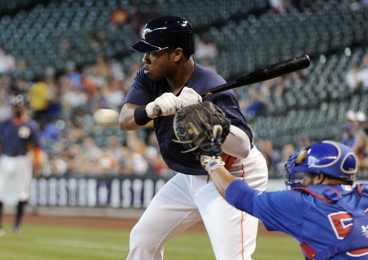 FILE - Houston Astros' Jonathan Singleton, left, takes an at-bat in front of Chicago Cubs catcher Welington Castillo (53) in the first inning of an exhibition baseball game March 30, 2013, in Houston. Singleton has signed a minor league contract with the Milwaukee Brewers. The former heralded first base prospect is attempting a big league comeback at the age of 30. (AP Photo/Pat Sullivan, File)