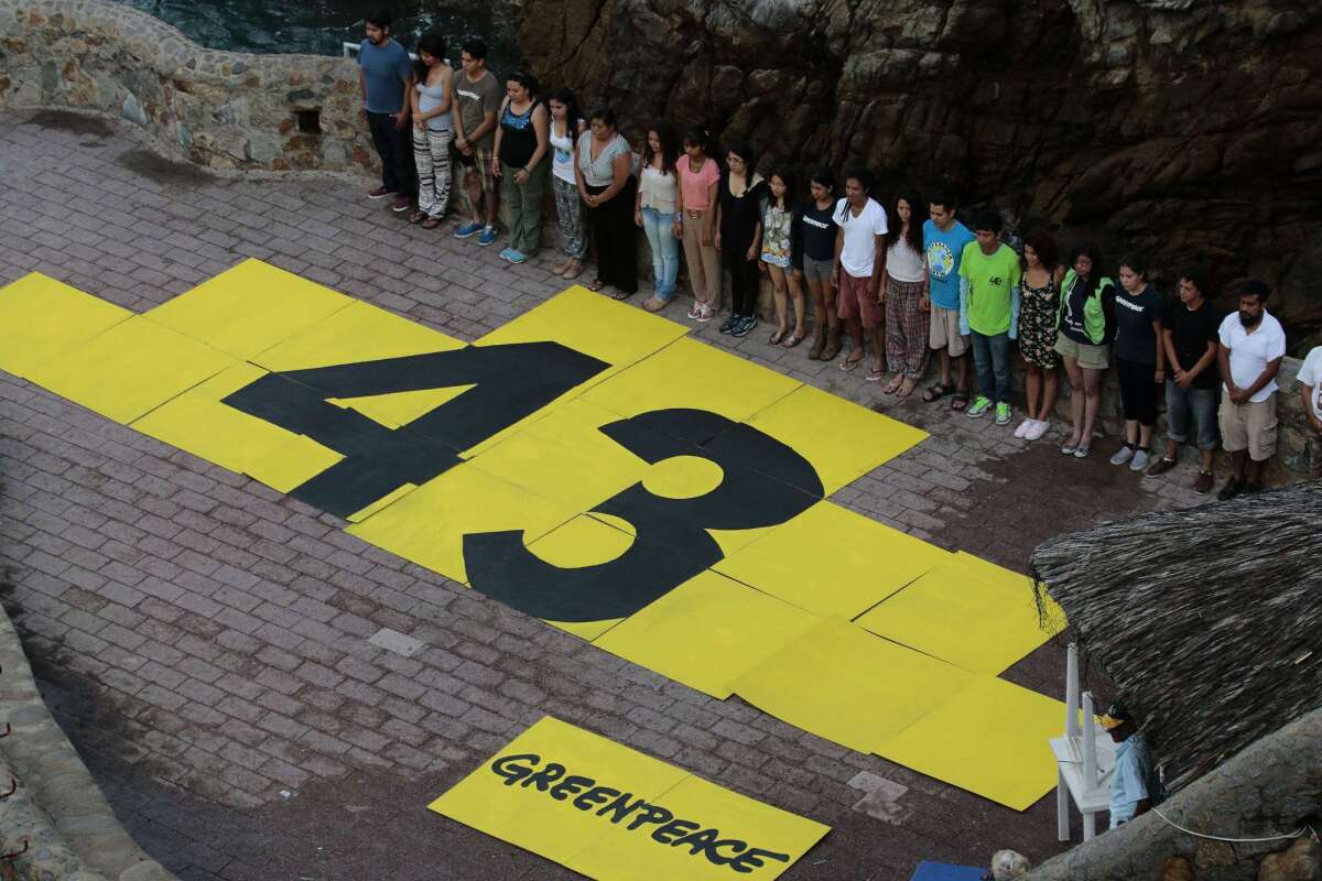 Greenpeace activists demonstrate Sept. 6 in Acapulco, Mexico, to draw attention to disappearance of 43 Mexican students last year.