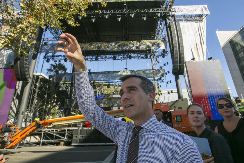 Los Angeles Mayor Eric Garcetti tours the construction of stages for the Made in America Festival in downtown Los Angeles on Thursday.