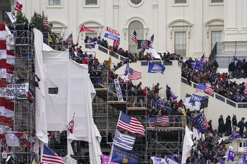 Trump supporters gather outside the Capitol, Wednesday, Jan. 6, 2021, in Washington. As Congress prepares to affirm President-elect Joe Biden's victory, thousands of people have gathered to show their support for President Donald Trump and his claims of election fraud. (AP Photo/John Minchillo)