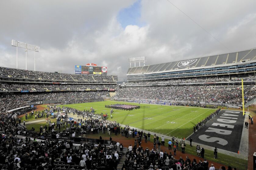 Oakland fans watch the host Raiders play the Buffalo Bills on Dec. 21, 2014.