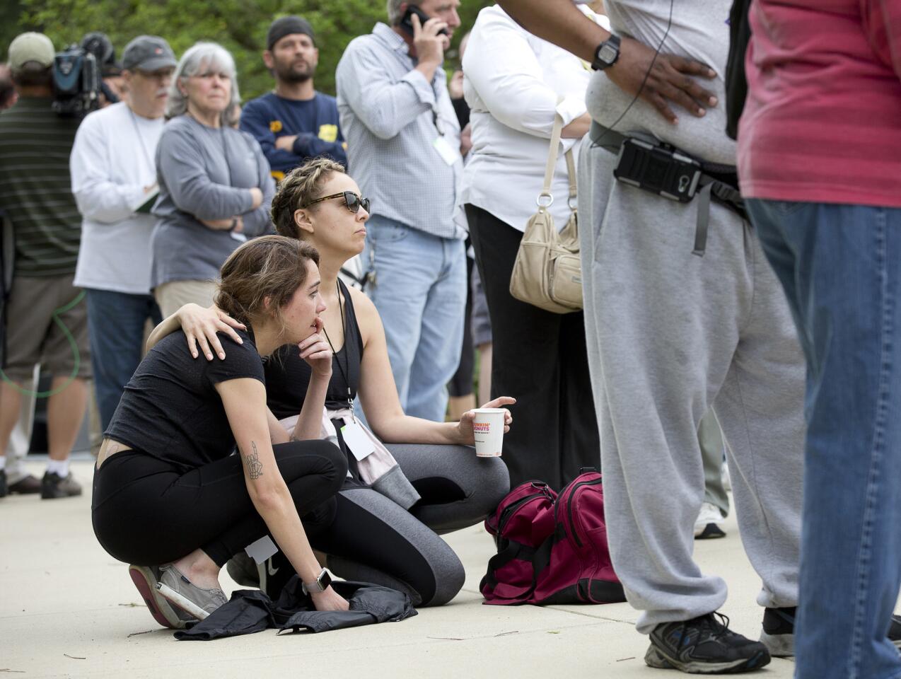 Kali Harris, left, and Kelly McMillan, right, wait outside of the Howard County Government offices to be escorted to their properties on Main Street to gather belongings and begin to assess their damages on Tuesday, May 29, 2018. Harris lives and works on Main Street at Salon Marielle and McMillan owns property on Main Street.