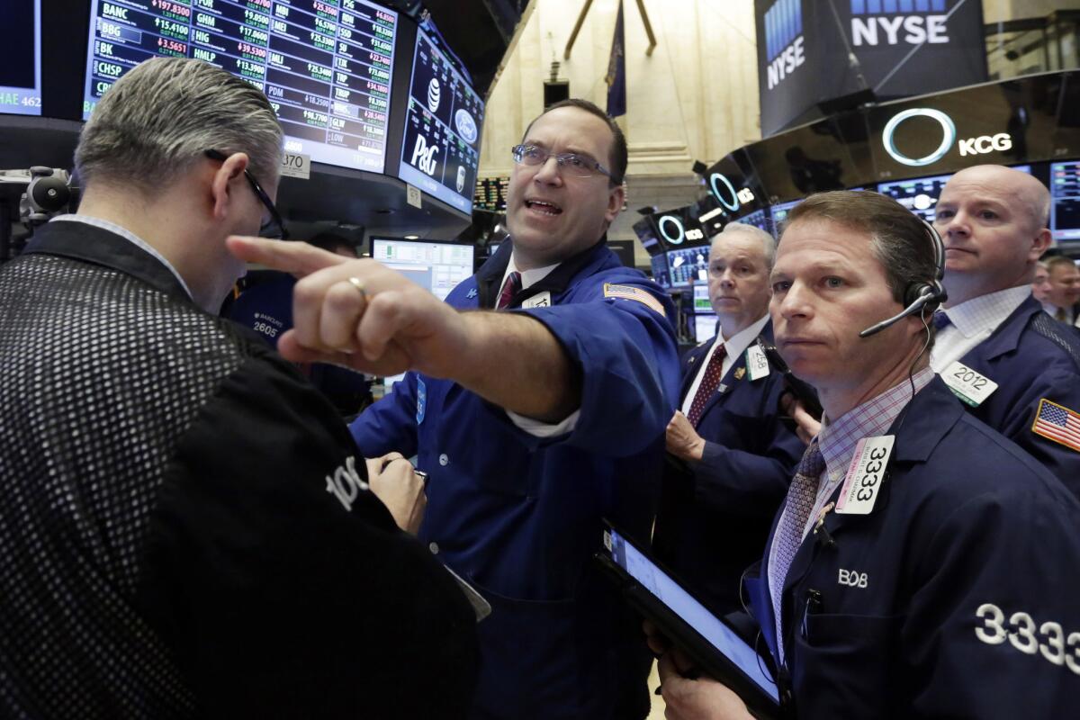 A specialist reaches out to traders on the floor of the New York Stock Exchange on Wednesday.
