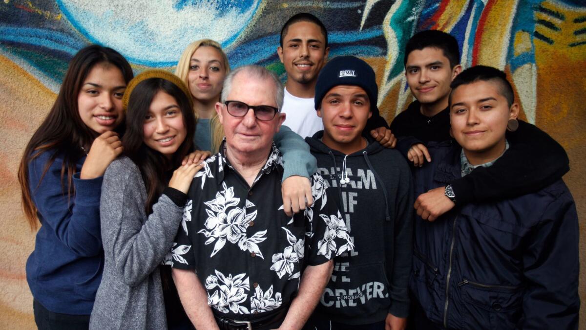 Duffy surrounded by admiring students in 2013 at Phoenix High School in Mar Vista, where he resumed teaching and abandoned his natty attire. He chose to work with teenagers who had struggled in a traditional campus setting.