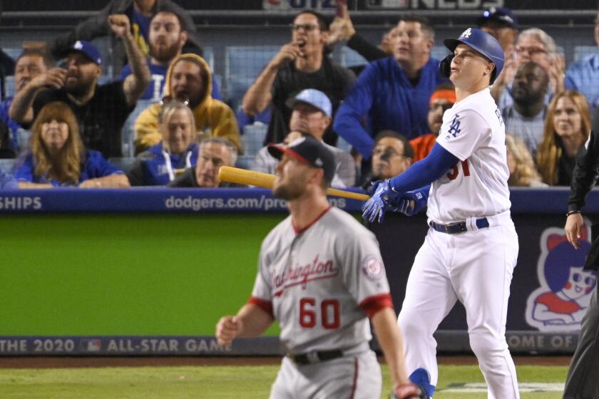 Dodgers right fielder Joc Pederson watches his home run off Washington Nationals relief pitcher Hunter Strickland during the eighth inning of Game 1 of baseball's National League Divisional Series on Thursday, Oct. 3, 2019, in Los Angeles. (AP Photo/Mark J. Terrill)