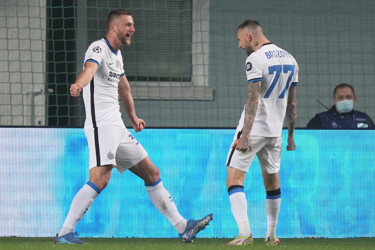 Inter Milan's Milan Skriniar, left, celebrates after scoring his side's second goal during the Champions League, group D soccer match, between Sheriff Tiraspol and Inter Milan at the Sheriff Stadium in Tiraspol, the capital of the breakaway region of Transnistria, a disputed territory unrecognized by the international community, in Moldova, Wednesday, Nov. 3, 2021. (AP Photo/Dmitri Lovetsky)