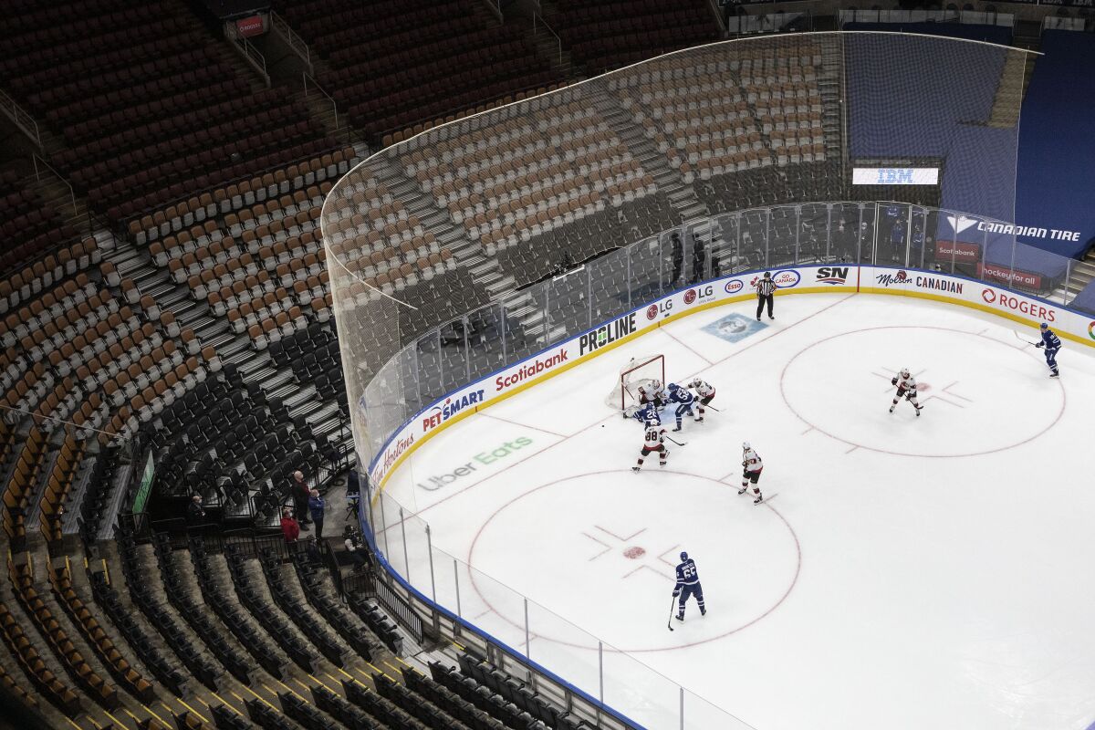 Toronto Maple Leafs take on the Ottawa Senators in a nearly empty Scotiabank arena during the first period of an NHL hockey game, Saturday, Jan. 1, 2022 in Toronto. (Chris Young/The Canadian Press via AP)