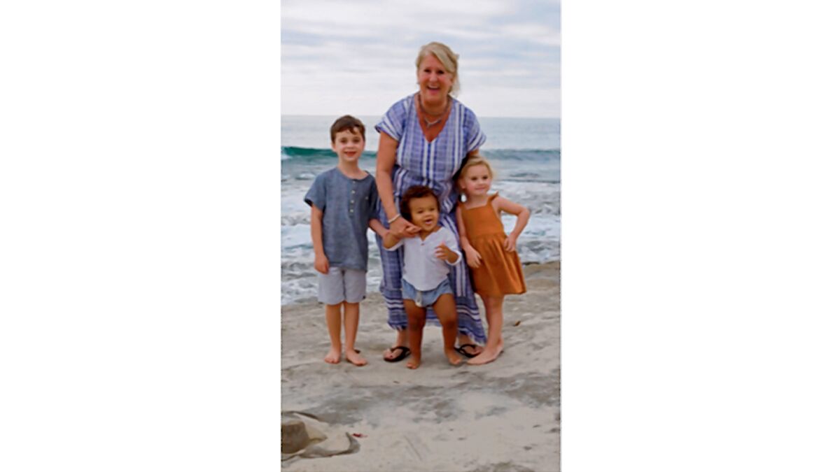 Education Consultant Mary Sue Lindsay on the beach with her grandchildren