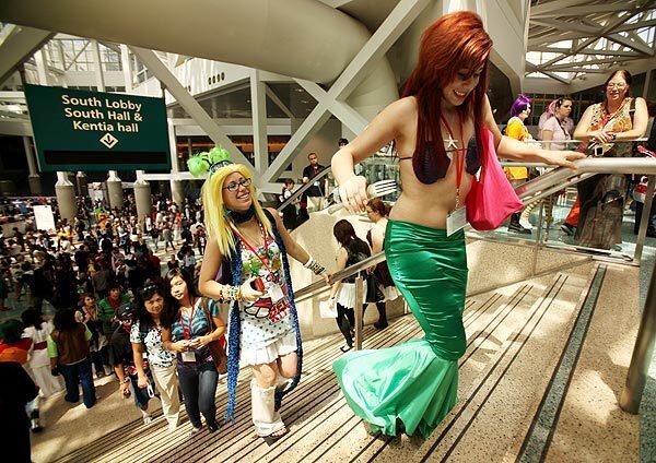 Lauren Wills, 18, of Nevada, dressed as Ariel from "The Little Mermaid," has difficulty climbing some steps as she walks through the Los Angeles Convention Center with her sister Kathryn Wills following close behind in Japanese street fashion. The Anime Expo -- the world's largest celebration of animation and Japanese comics -- has been held in Los Angeles the last two years.