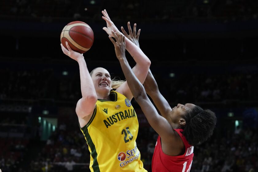 Canada's Kayla Alexander, right, attempts to block a shot by Australia's Lauren Jackson during their bronze medal game at the women's Basketball World Cup in Sydney, Australia, Saturday, Oct. 1, 2022. (AP Photo/Mark Baker)