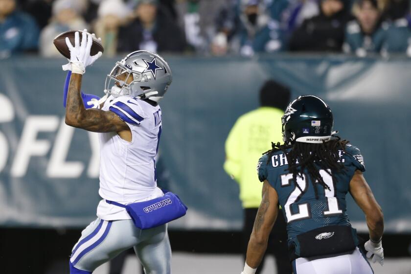 Dallas Cowboys wide receiver Ced Wilson catches a pass over Philadelphia Eagles defensive back Andre Chachere.