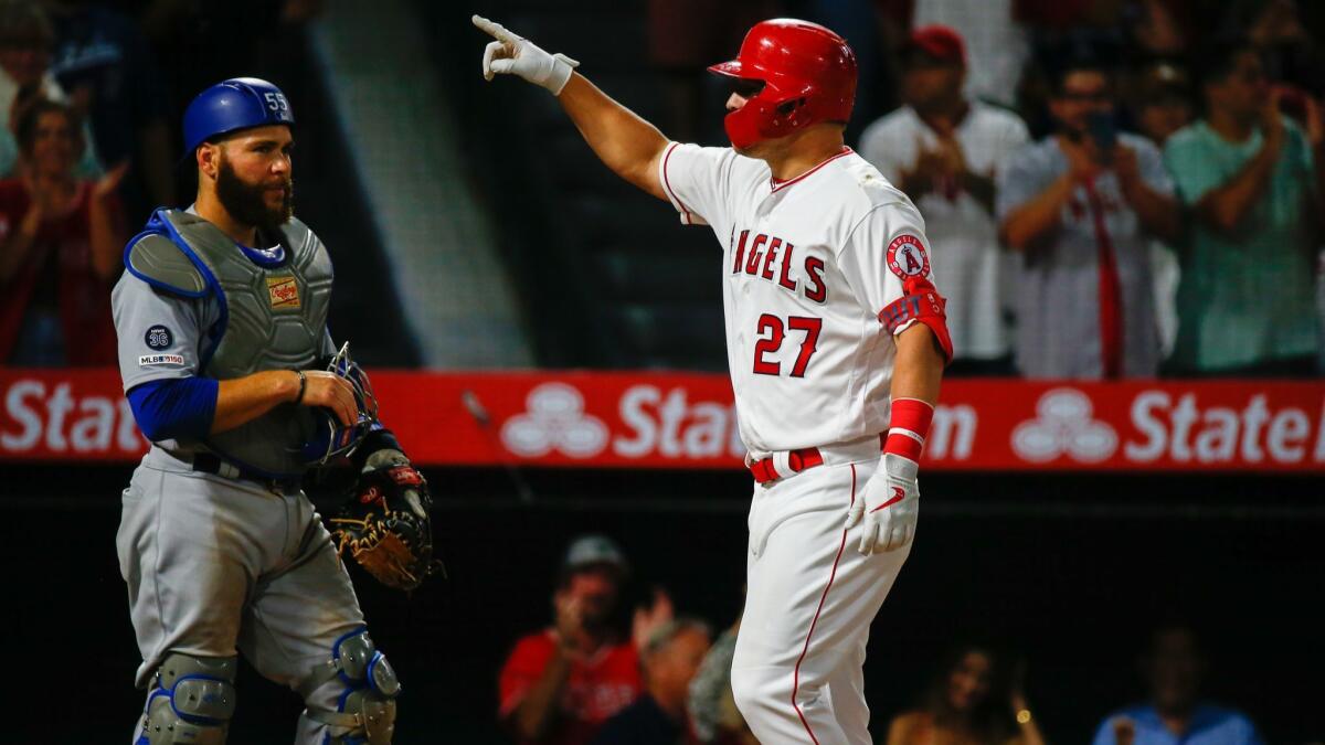 Angels center fielder Mike Trout gestures as he crosses the plate after hitting a home run against the Dodgers at Angel Stadium on June 10.