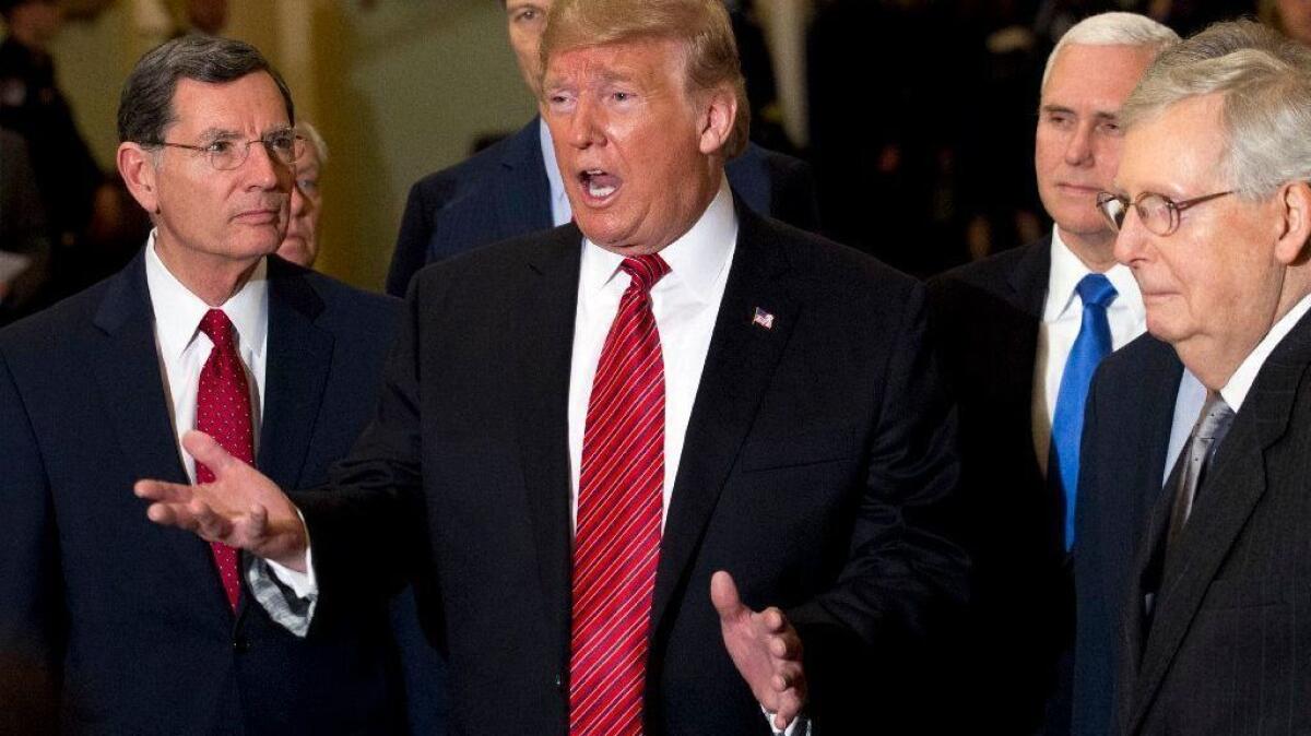 President Trump, with Republican lawmakers, talks to reporters on Capitol Hill on Wednesday.