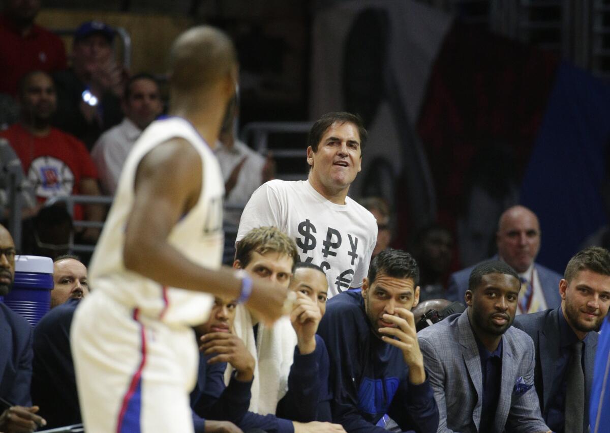 Dallas Mavericks owner Mark Cuban, center, looks at Clippers guard Chris Paul during the second half of a game on Oct. 29.