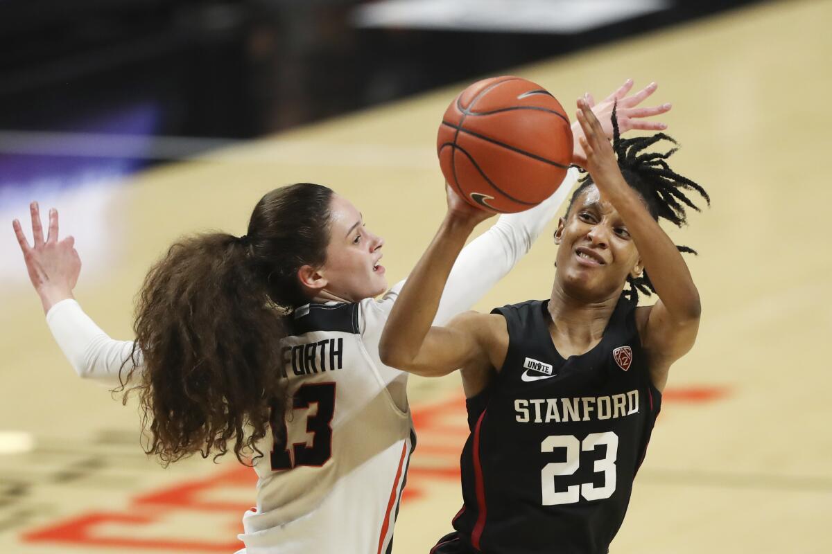 FILE - Stanford's Kiana Williams (23) avoids a block by Oregon State's Sasha Goforth (13) during the first half of an NCAA college basketball game in Corvallis, Ore., in this Saturday, Feb. 13, 2021, file photo. No. 4 Stanford remains the class of the conference as it enters a Pac-12 women’s tournament loaded with strong teams at the top, including No. 9 UCLA and No. 11 Arizona. (AP Photo/Amanda Loman, File)
