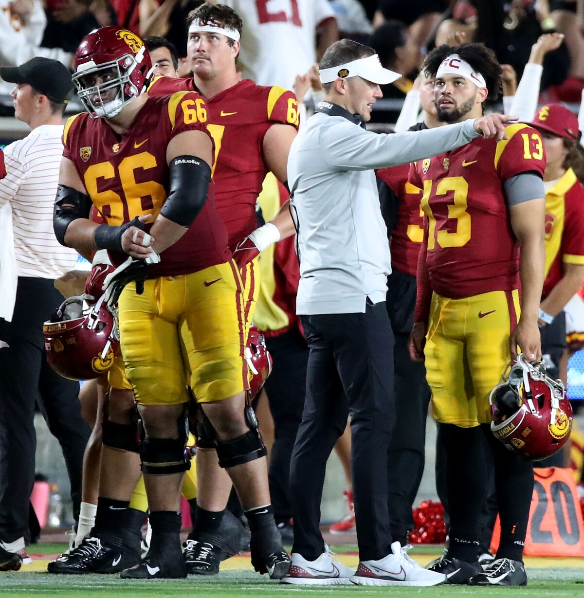 USC coach Lincoln Riley gestures while speaking to quarterback Caleb Williams on the touchline