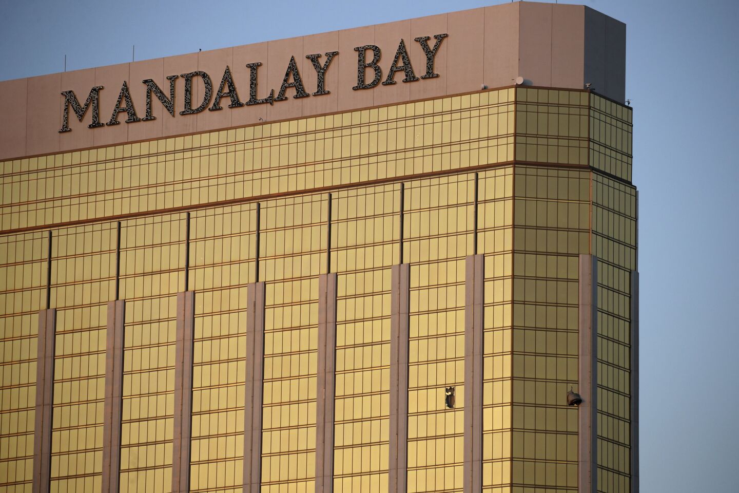Drapes billow from broken windows Monday at the Mandalay Bay Resort and Casino on the Las Vegas Strip. Police say gunman Stephen Paddock targeted festival-goers from the resort and was found dead inside a hotel room.