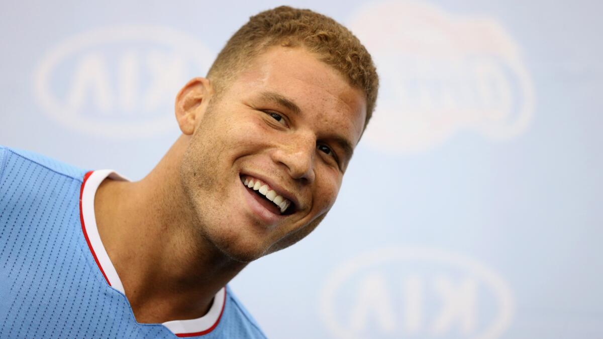 Clippers power forward Blake Griffin smiles while posing for photographs during the team's media day Monday.