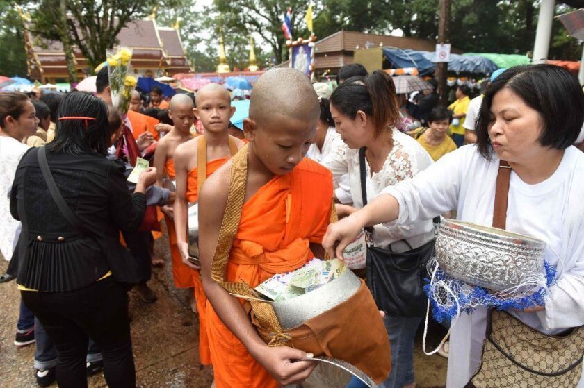 Eleven members of the rescued Thai soccer team take part in ceremony at Buddhist temple on Wednesday.