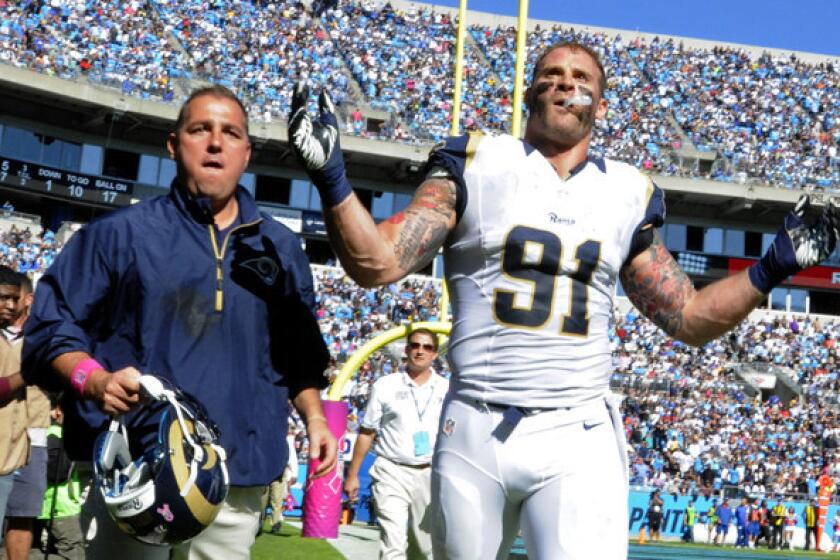 Rams defensive lineman Chris Long gestures to the crowd in Charlotte, N.C., as he leaves the field after being ejected during a skirmish with Carolina Panthers players in the second half Sunday.