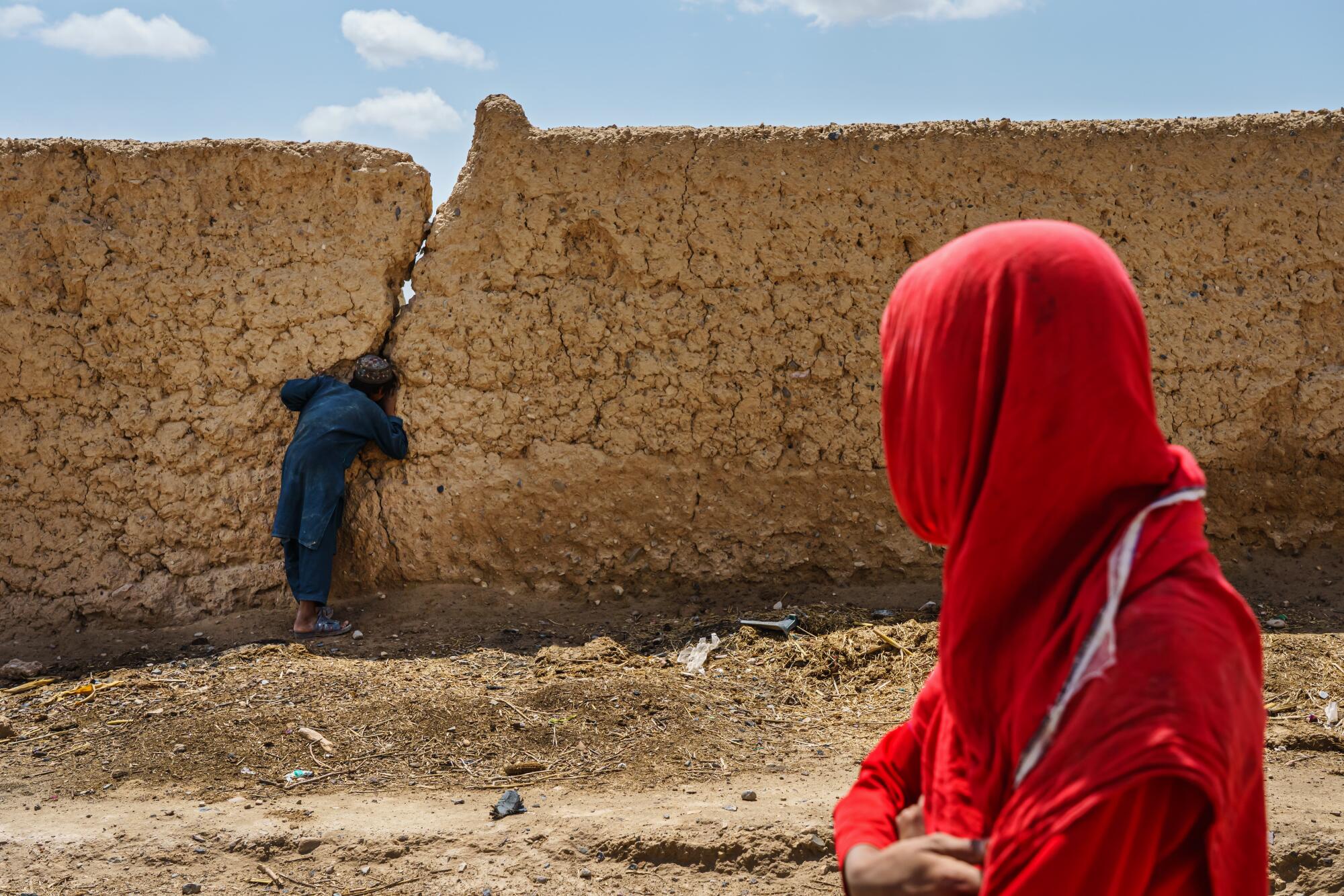 Children walk back to their family homes that were destroyed in the fighting between government forces and the Taliban.