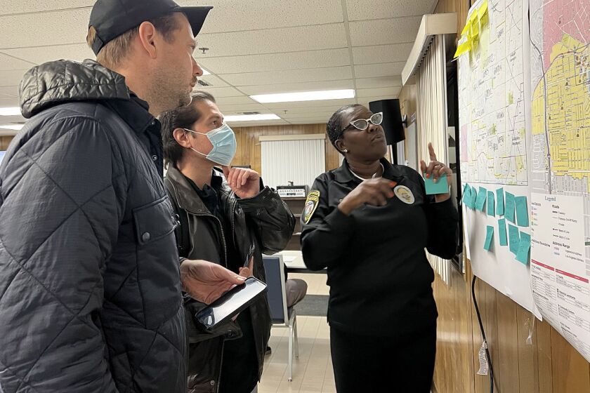 Homeless count volunteers JC Cangilla and David Gaxiola listen to Inglewood deployment site coordinator Cinder Eller-Kimbell describe the area they will be counting. On Jan, 25, 2023.