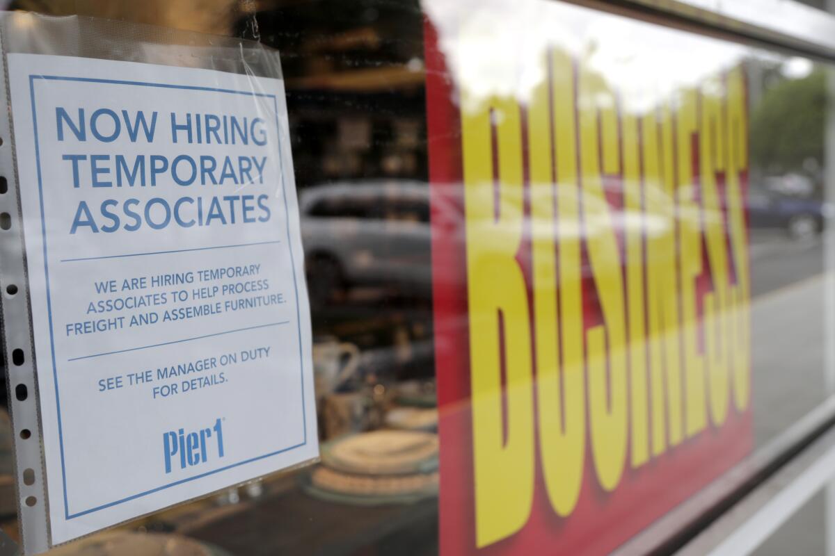 A sign advertises hiring of temporary associates at Pier 1