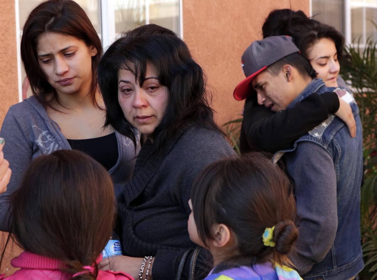 Aracelia Sandoval, center, flanked by family members, grieves for her 19-year-old son Jerry Arredondo Jr., who was killed in a hit-and-run incident in South Los Angeles on Tuesday.