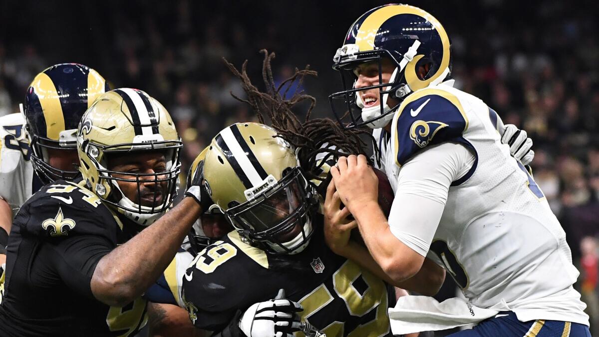 Rams quarterback Jared Goff is sacked by Saints linebacker Dannell Ellerbe (59) and defensive end Cameron Jordan during the fourth quarter.
