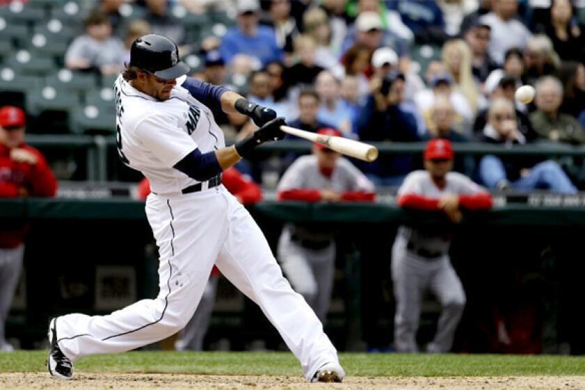 Seattle Mariners' Michael Morse hits a home run against the Angels in the eighth inning.