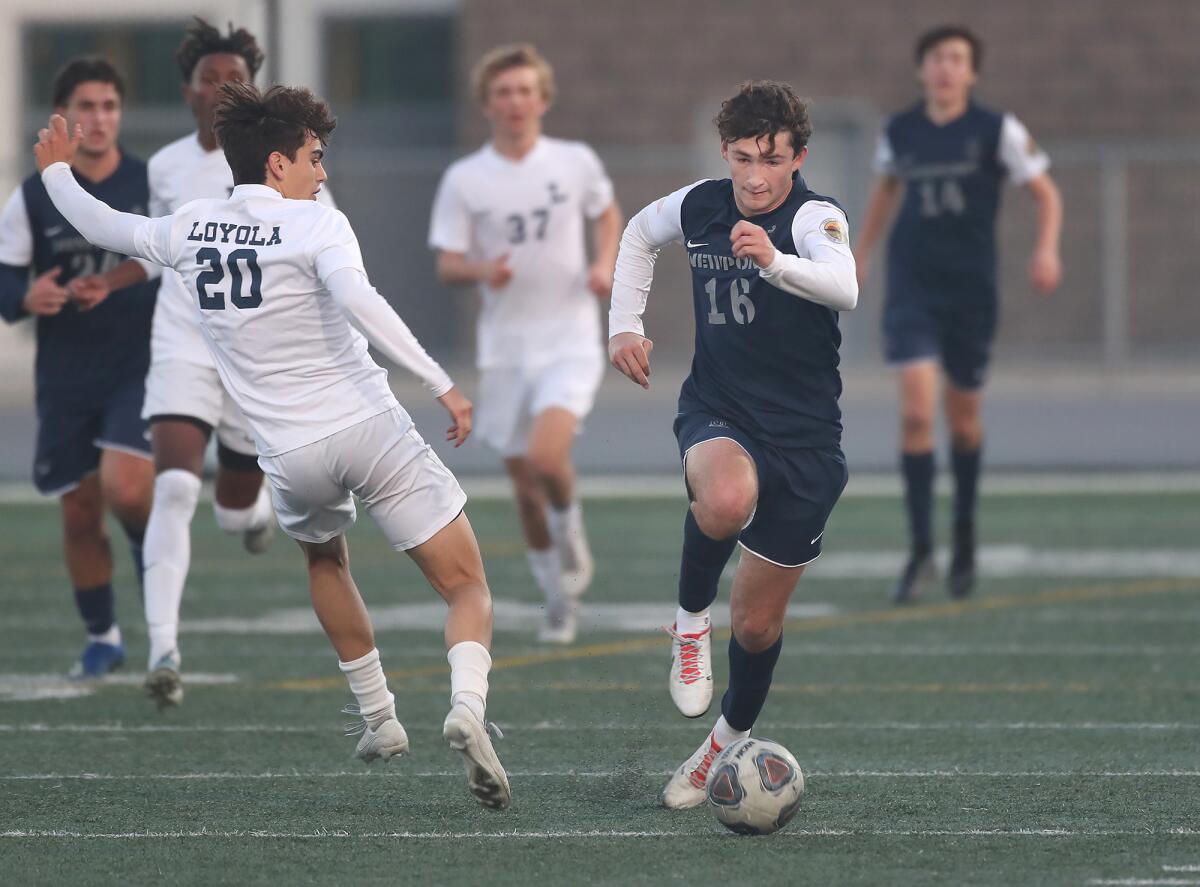 Newport Harbor's Jake Shubin (16) steals the ball from Loyola's Charlie McMillan (20) on Friday.