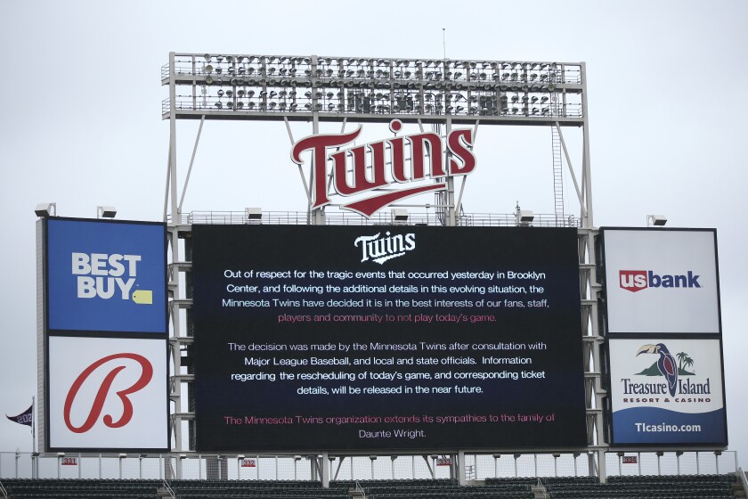 The scoreboard at Target Field explains the postponement of the baseball game between the Minnesota Twins and Boston Red Sox on Monday, April 12, 2021, in Minneapolis. The Minnesota Twins have postponed their game against the Boston Red Sox because of safety concerns following the fatal police shooting of a Black man in a nearby suburb. (AP Photo/Stacy Bengs)