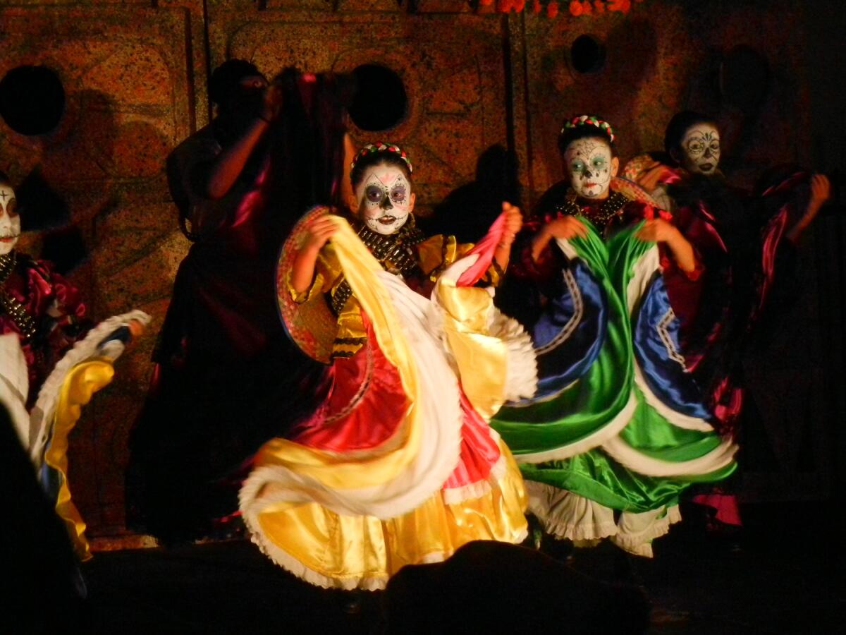 Young girls in dresses, face paint and garlands for Día de los Muertos (the Day of the Dead).