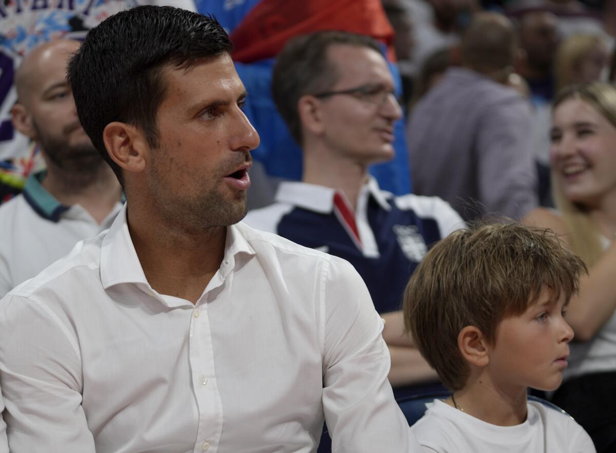 Novak Djokovic with his son Stefan before a basketball game between Serbia and Greece.