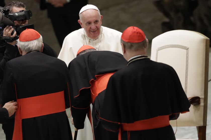 Pope Francis greets cardinals in the Paul VI Hall at the Vatican after an audience with students and teachers of the LUMSA Catholic University, Thursday, Nov. 14, 2019. (AP Photo/Alessandra Tarantino)