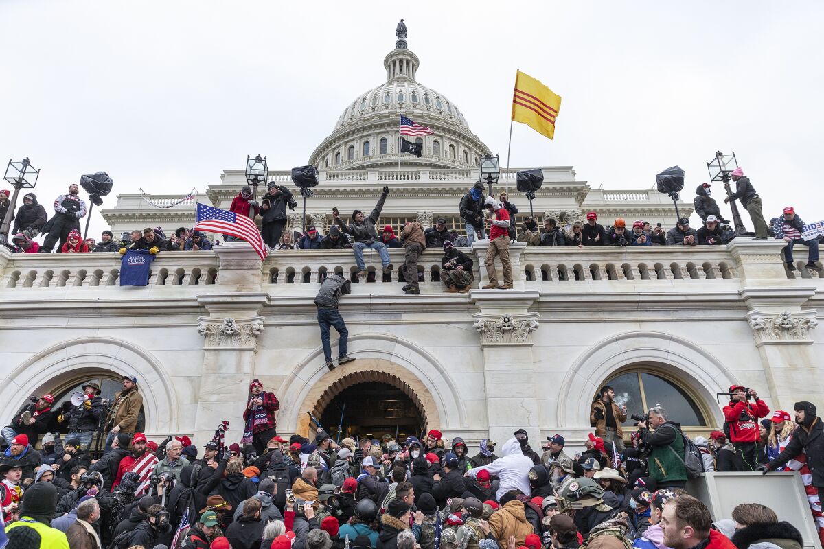 Rioters trying to overturn the 2020 election storm the U.S. Capitol on Jan. 6. 