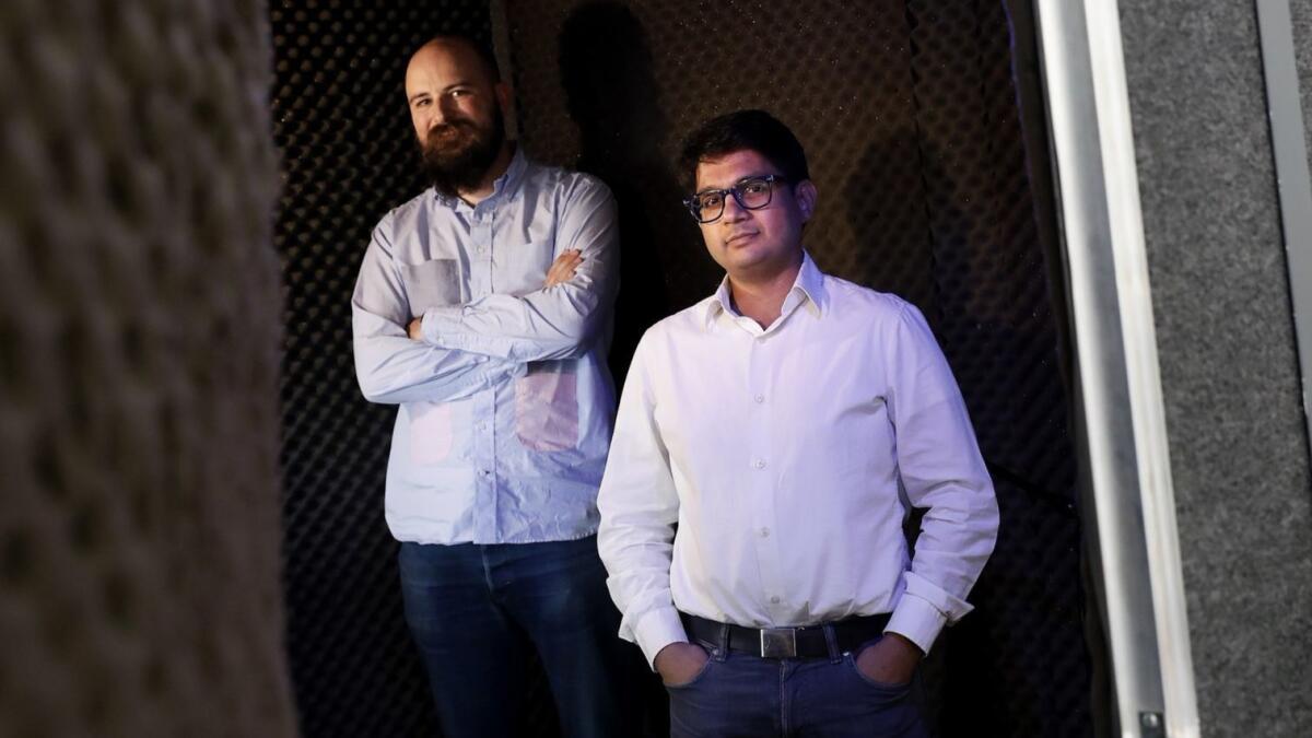 Hosts and executive directors Jesse Thorn, left, and Bikram Chatterji of podcasting production company Maximum Fun in the recording booth at their L.A. office on Oct. 23.
