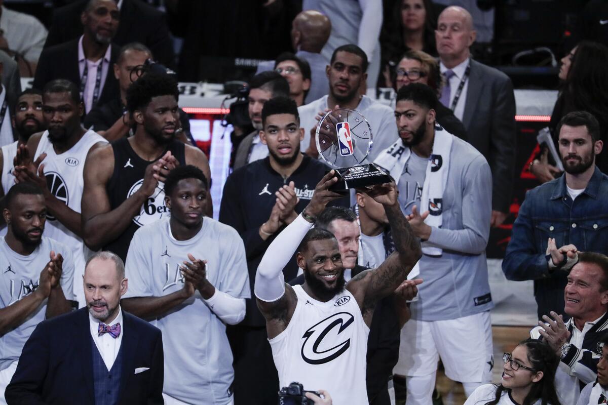 LeBron James is awarded the MVP trophy after leading Team LeBron to a 148-145 win over Team Stephen at the 2018 NBA All-Star game at Staples Center.
