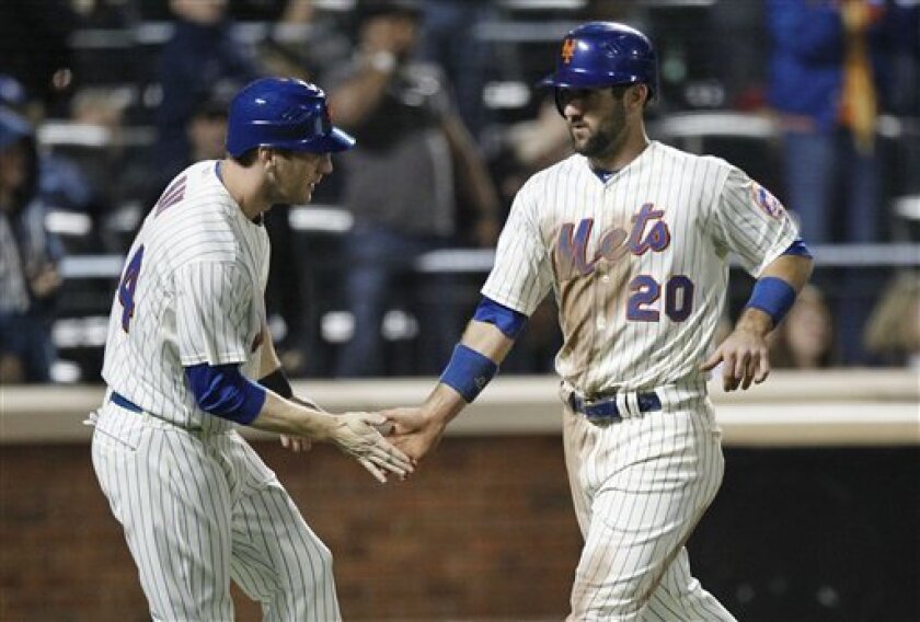 New York Mets' Jason Bay (44) celebrates with teammate Jason Pridie (20) after both scored on a single by Justin Turner during the eighth inning of a baseball game against the Los Angeles Dodgers Saturday, May 7, 2011, at Citi Field in New York. The Mets won the game 4-2. (AP Photo/Frank Franklin II)