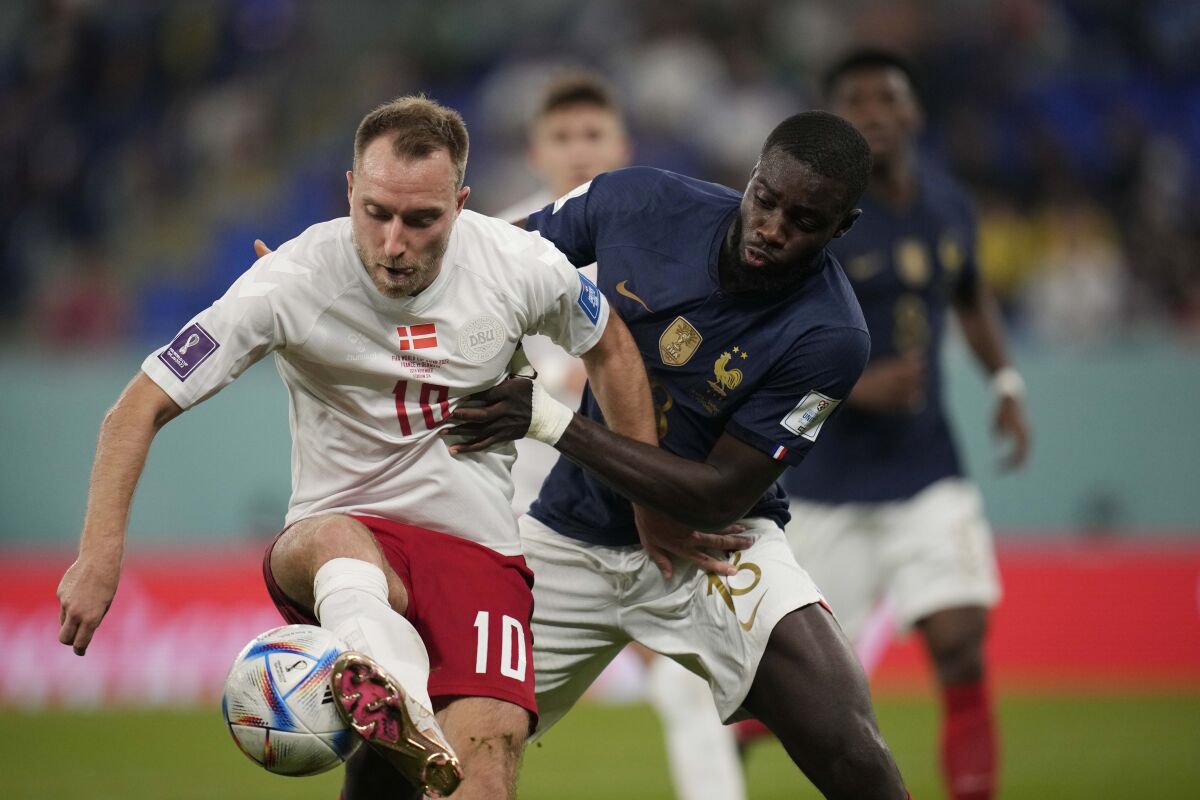 Denmark's Christian Eriksen, left, competes for the ball with France's Dayot Upamecano during the World Cup group D soccer match between France and Denmark, at the Stadium 974 in Doha, Qatar, Saturday, Nov. 26, 2022. (AP Photo/Christophe Ena)
