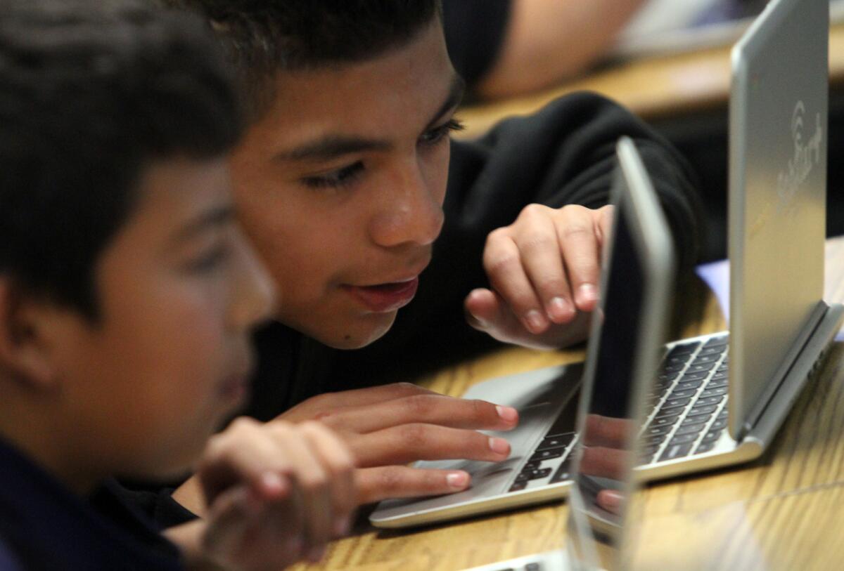 Students in Pinacate Middle School in Perris work on Chromebooks, which will soon be tried out in L.A. Unified high schools.