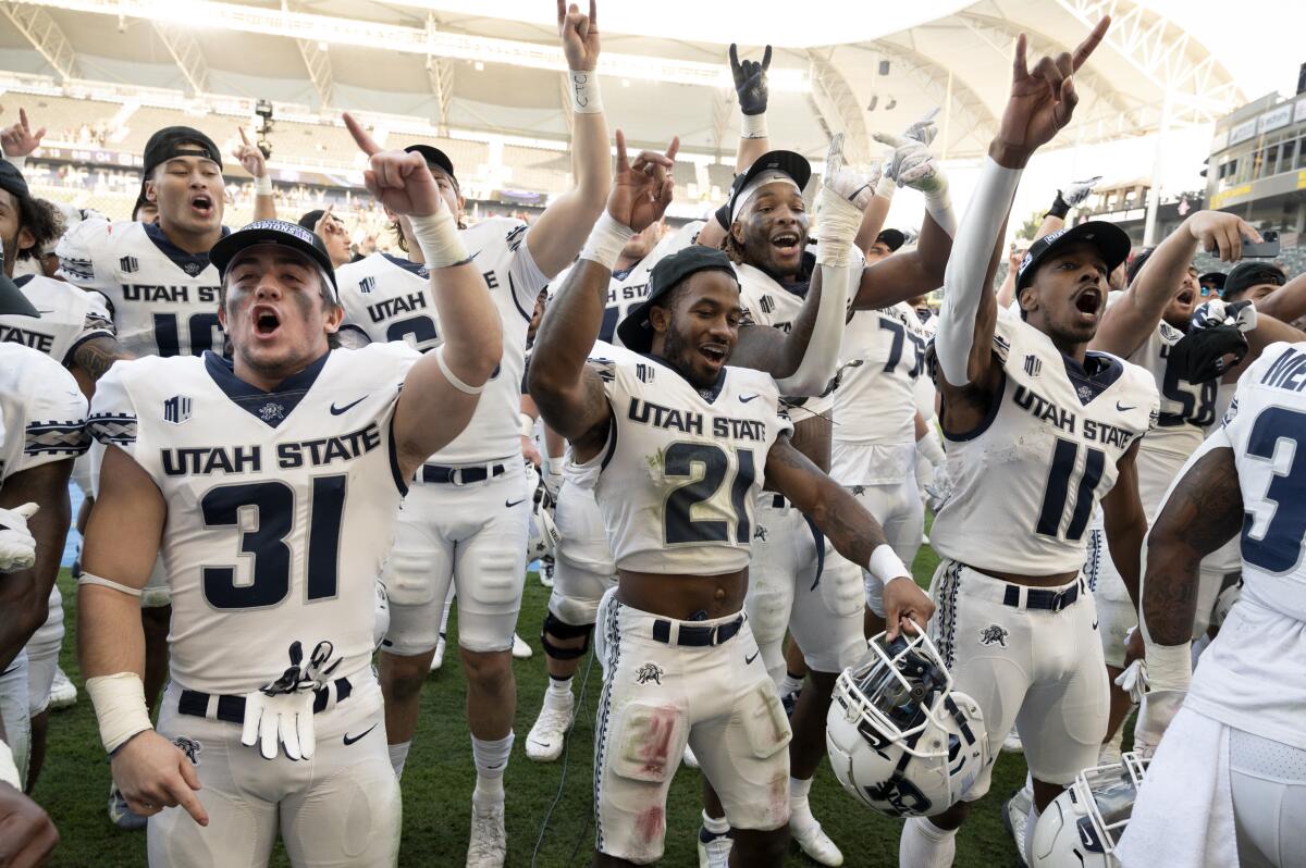 Utah State celebrates after defeating the San Diego State during an NCAA college football game for the Mountain West Conference Championship, Saturday, Dec. 4, 2021, in Carson, Calif. (AP Photo/John McCoy)