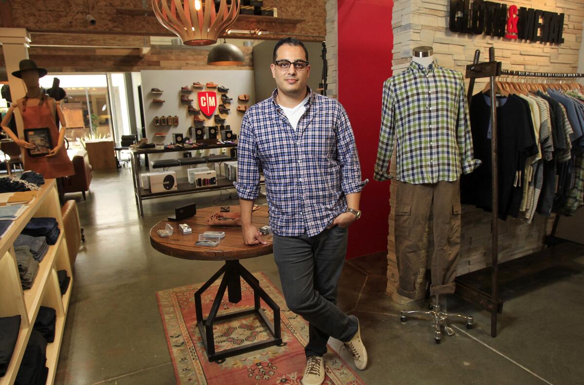 Owner Scott Sablan poses for a photo at Cloth & Metal, a specialty men's retailer located in the OC Mix in Costa Mesa. (Kevin Chang/ Daily Pilot)