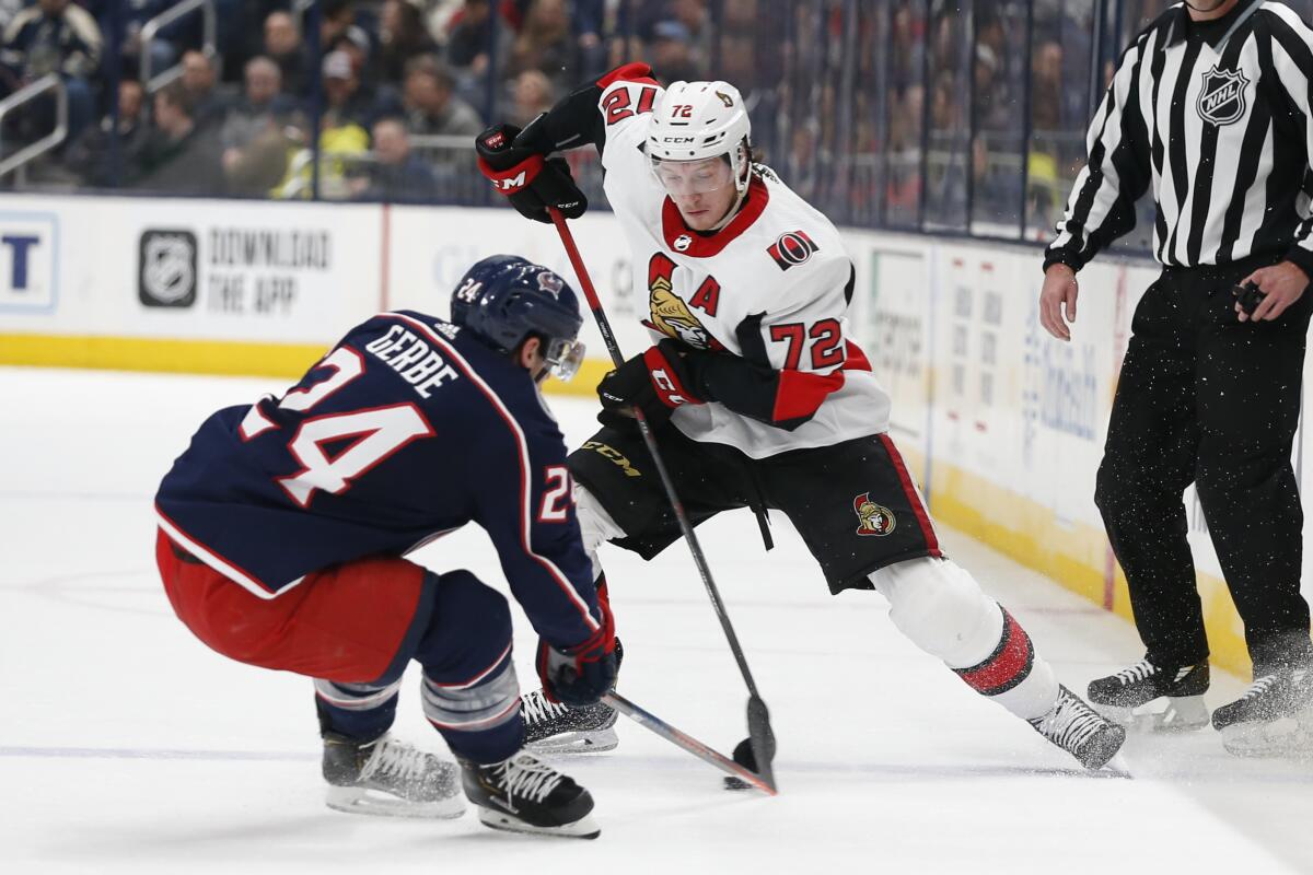 Ottawa Senators' Thomas Chabot carries the puck across the blue line as Columbus Blue Jackets' Nathan Gerbe defends