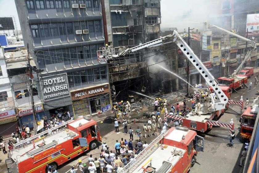 Firefighters douse a fire which broke out in a restaurant and hotel near the Patna Junction railway station, in Patna, Bihar, India, Thursday, April 25, 2024. (AP Photo/Aftab Alam Siddiqui)