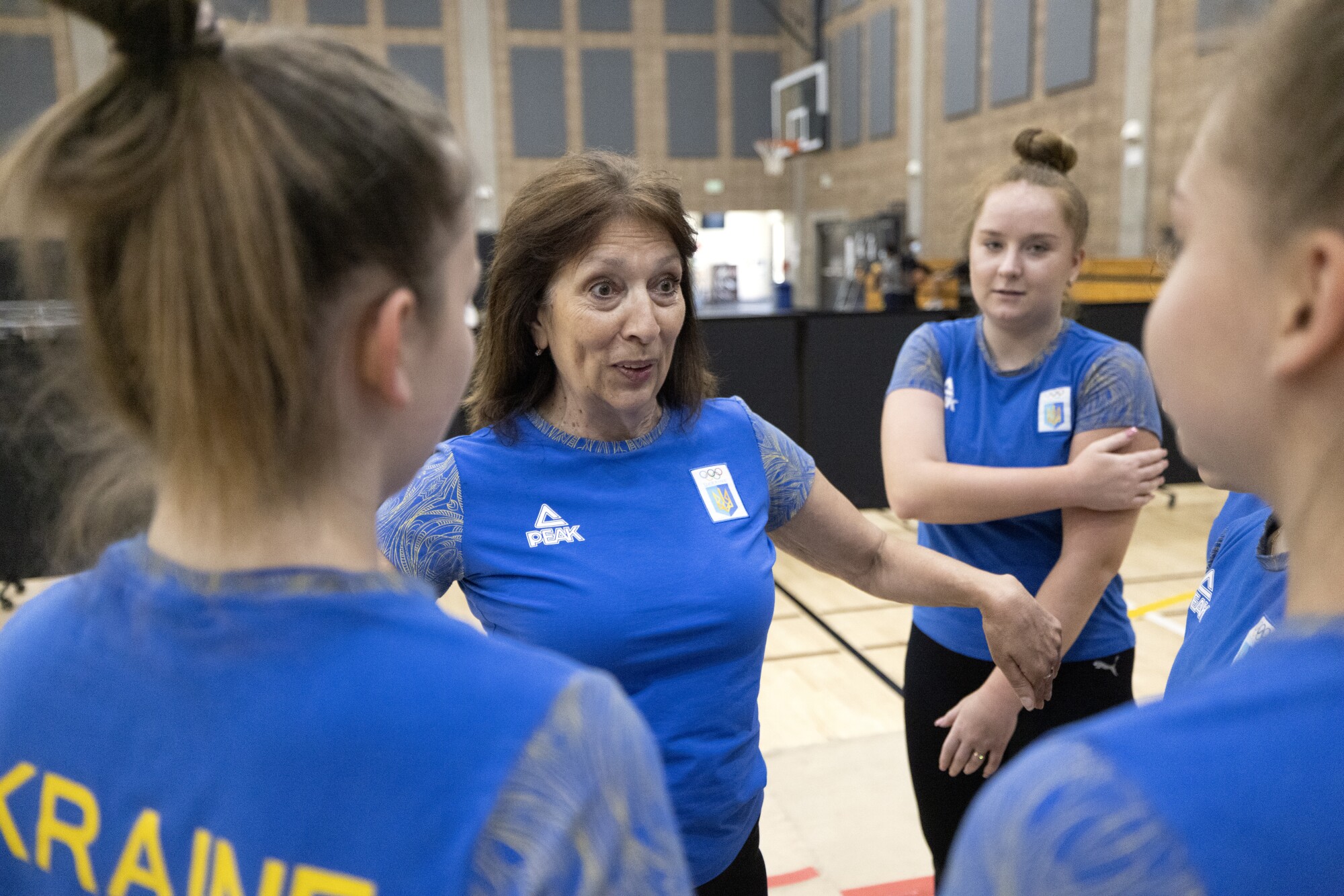 Head coach Iryna Gutnik, center, talks to the Ukranian team during practice.