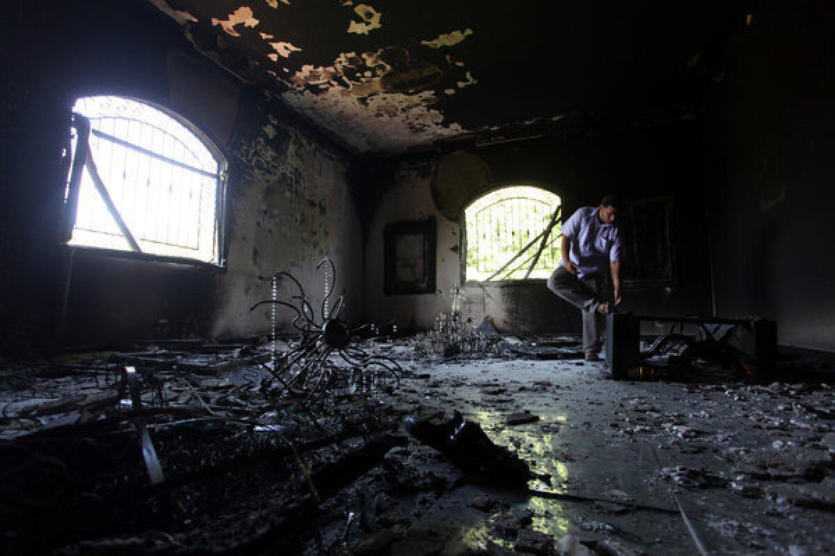 A Libyan man investigates the inside of the U.S. Consulate after an attack that killed four Americans, including Ambassador Chris Stevens, on the night of Sept. 11, in Benghazi, Libya.