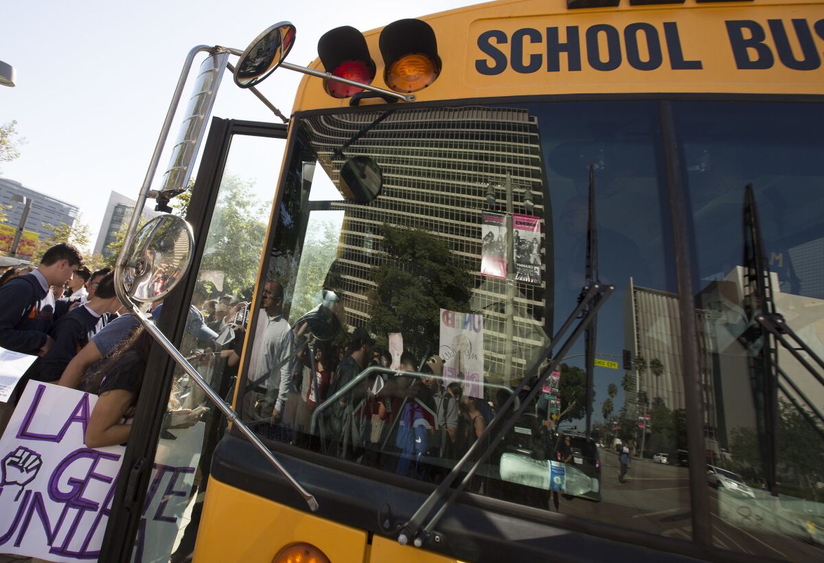 Students board an L.A. bus back to school after a November walkout. The school district disclosed this week that it fired a bus supervisor and pressured two subordinates to resign for alleged drinking and drug use.
