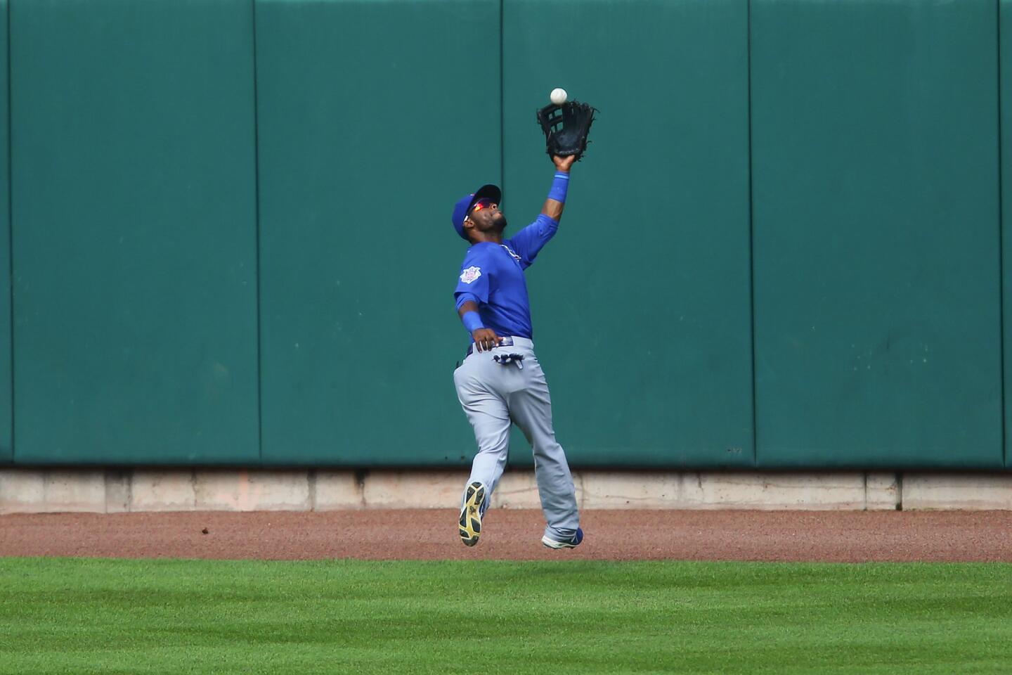 Arismendy Alcantara catches a fly ball in the ninth inning.