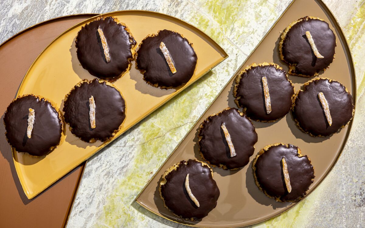 Orange and chocolate combine in these crisp shortbread cookies, coated in crunchy sugar and topped with candied orange peel.